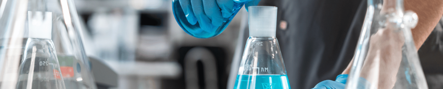  Scientist measuring liquid in a lab setting, ensuring REACH certification compliance. 