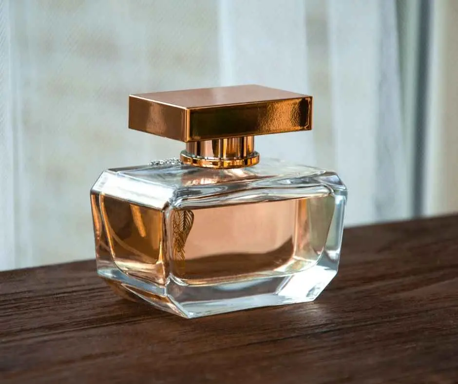 Clear glass bottle filled with Alcohol for Perfume and finished with a gold lid