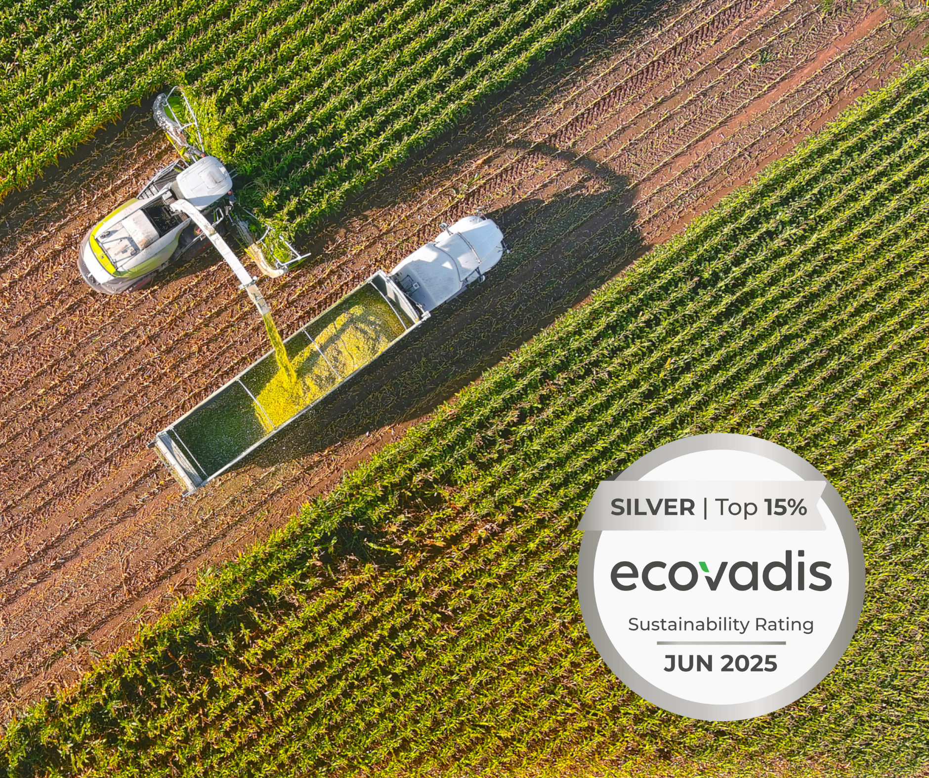 Aerial view of a harvester loading crops into a trailer in a green field, with an EcoVadis Silver Sustainability Rating badge dated June 2025.